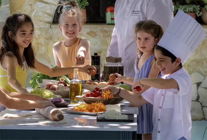 children enjoying a cooking class at Amirandes Grecotel Resort in Crete, Greece