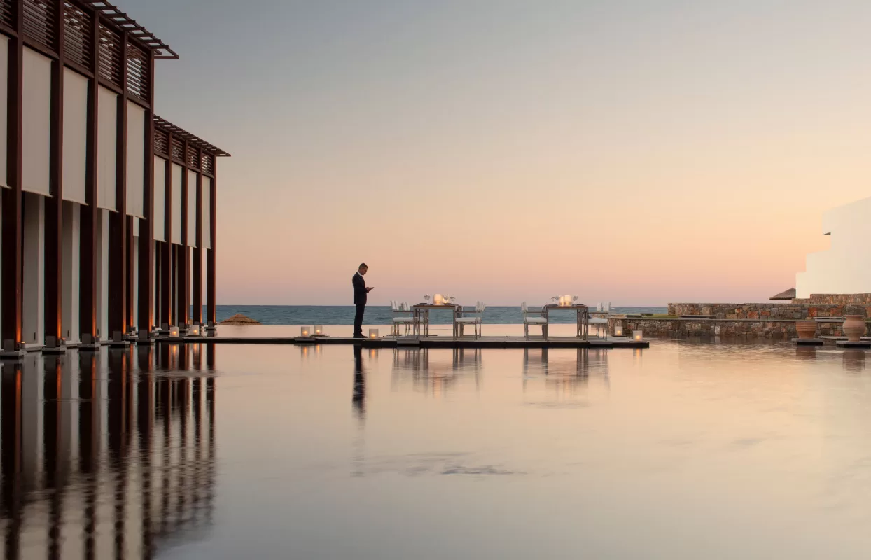 Butler setting up a private dinner at sunset at Amirandes