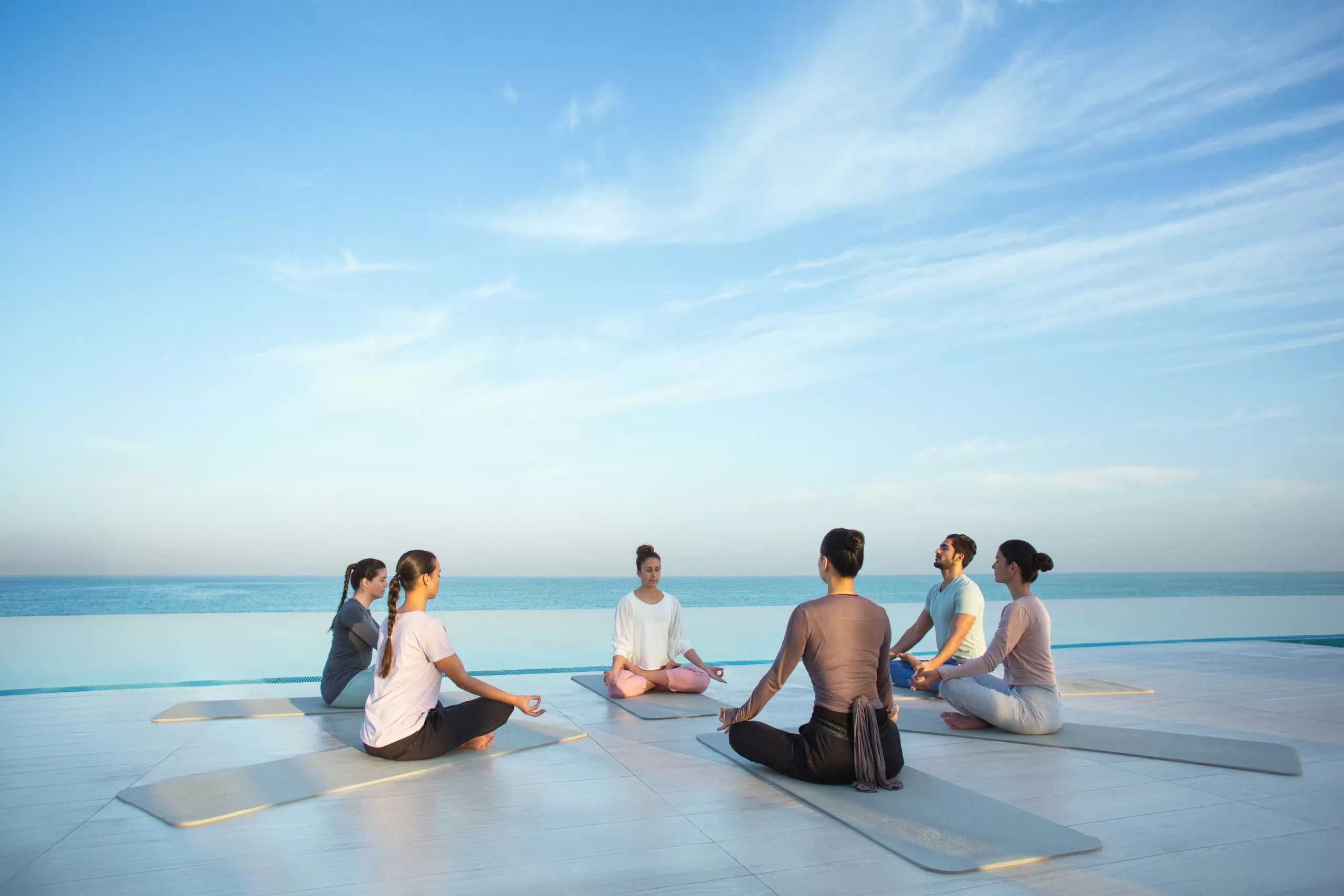 six people doing yoga at Jumeirah at Saadiyat island